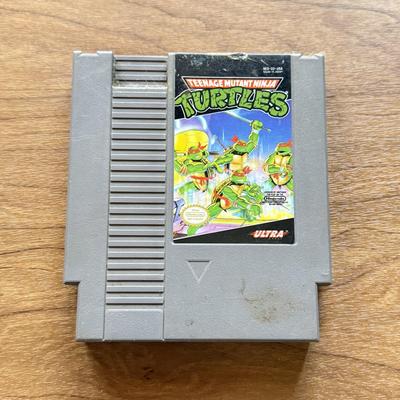 LOT 108F: 1980s-90s NES Game Cartridges: Wheel of Fortune, Millipede, Teenage Mutant Ninja Turtles, Kickle Cubicle, Disney's The...