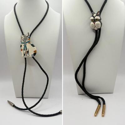 LOT 190J: Two Painted Clay Cat Bolo Ties