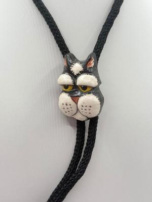 LOT 190J: Two Painted Clay Cat Bolo Ties