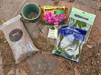 Garden pot with stand - partial bag of rose food - crafting moss - and a unopened bag of Odla hydroponic clay beads