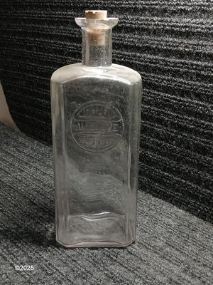 Antique embossed bottle with cork stopper