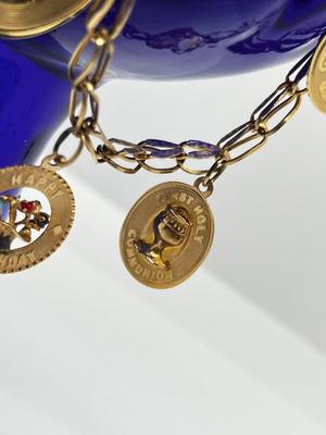 LOT 86: 14K Yellow Gold Charm Bracelet and Vintage Charms - 12.46 GTW