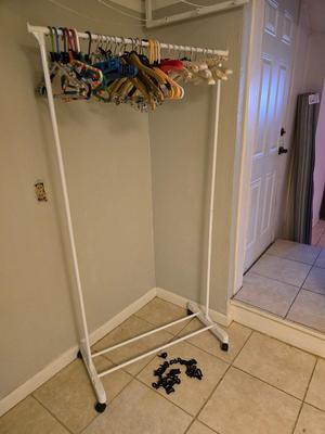 Portable Clothes Rack on casters with an assortment of Hangers