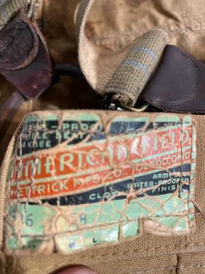 Vintage coat, army bags, and suspender pants