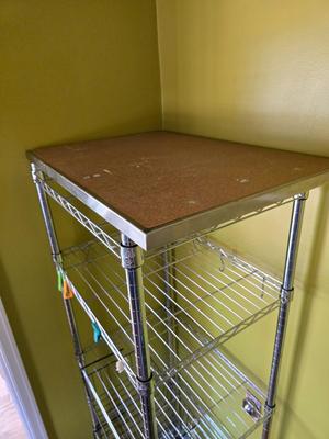 Stainless steel adjustable storage shelf with an assortment of hooks and clips - and some wood for shelves can honey do NSF Marked