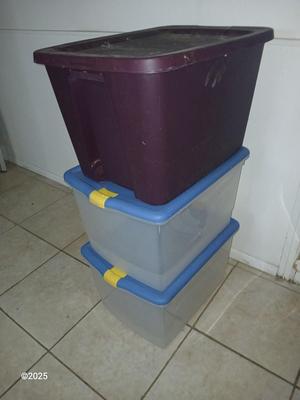 Three plastic storage totes with lids