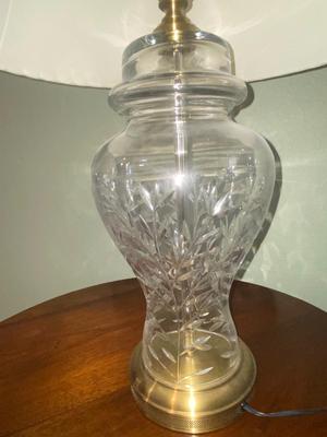 ANTIQUE WALNUT SIDE TABLE ON CASTERS AND A LEAD CRYSTAL CUT LAMP