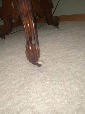 ANTIQUE WALNUT SIDE TABLE ON CASTERS AND A LEAD CRYSTAL CUT LAMP