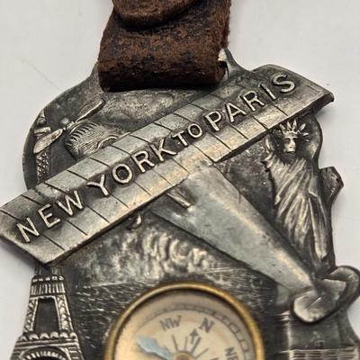 LOT 21: 1927 N.Y. to Paris Compass with Leather Strap Commemorating Charles Lindbergh's Flight