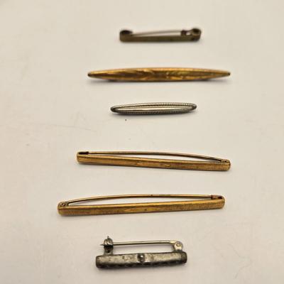 LOT 23: Costume Jewelry Including Gold Filled Ladies Brooch, Charms from Greece, Locket, Tie Bars, and More
