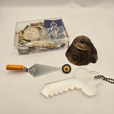 LOT 27: Vintage Cast Iron Shriner Fez Paperweight, Commemorative Free Mason Trowel, Lapel Pin, Keychain, and Small Box of Various Pins...