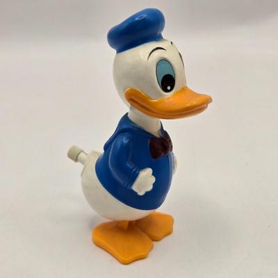 LOT 30: Poor Donald is Always Second Fiddle to Mickey: Vintage Donald Duck Squeak Toy, Kohner Donald Duck Push- Button Toy, Donald Duck...
