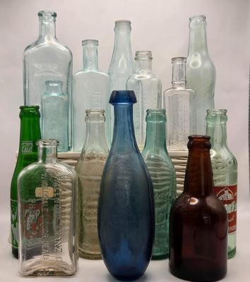 LOT 161: Multiple Vintage/Antique Glass Bottles Including Blue Tenpin Soda, Hires Root Beer, Flavoring Extracts, and More