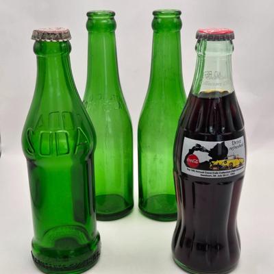 LOT 164: Have a Coke and a Smile: Multiple Vintage Coca-Cola Collectors Items Including Bottles, Glass Paperweight, Metal tray, and Much...