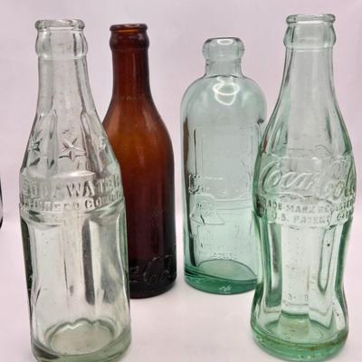 LOT 164: Have a Coke and a Smile: Multiple Vintage Coca-Cola Collectors Items Including Bottles, Glass Paperweight, Metal tray, and Much...