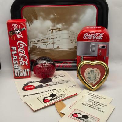LOT 164: Have a Coke and a Smile: Multiple Vintage Coca-Cola Collectors Items Including Bottles, Glass Paperweight, Metal tray, and Much...