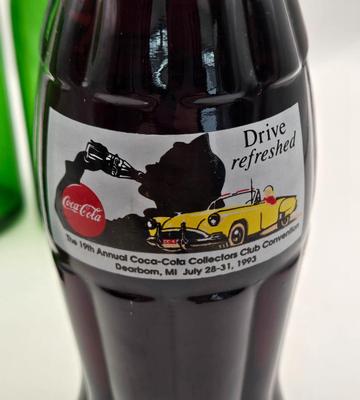 LOT 164: Have a Coke and a Smile: Multiple Vintage Coca-Cola Collectors Items Including Bottles, Glass Paperweight, Metal tray, and Much...