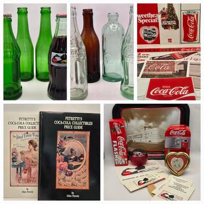 LOT 164: Have a Coke and a Smile: Multiple Vintage Coca-Cola Collectors Items Including Bottles, Glass Paperweight, Metal tray, and Much...