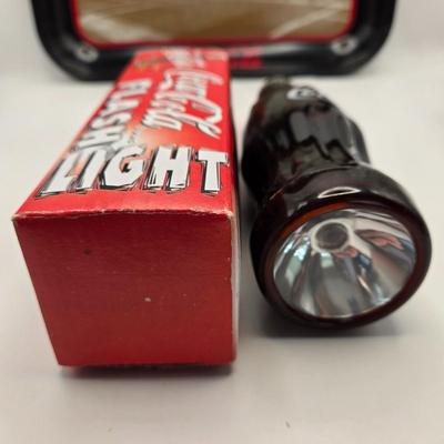 LOT 164: Have a Coke and a Smile: Multiple Vintage Coca-Cola Collectors Items Including Bottles, Glass Paperweight, Metal tray, and Much...