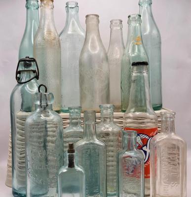 LOT 183: Multiple Vintage Glass Bottles Including Whistle, Scott's Emulsion, Hires, Big Frosty, and Many More
