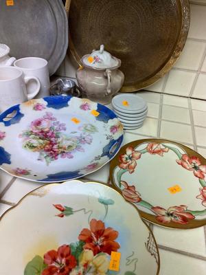 Variety of dishware, including Pyrex, brass platter and decorative plates