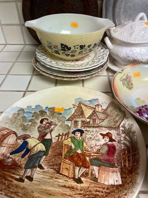 Variety of dishware, including Pyrex, brass platter and decorative plates