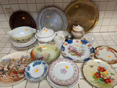 Variety of dishware, including Pyrex, brass platter and decorative plates