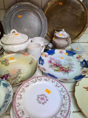 Variety of dishware, including Pyrex, brass platter and decorative plates