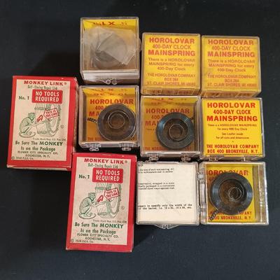 LOT 415: Large Collection of Clock Parts - Weights, Springs, Pendulums, Hands & More
