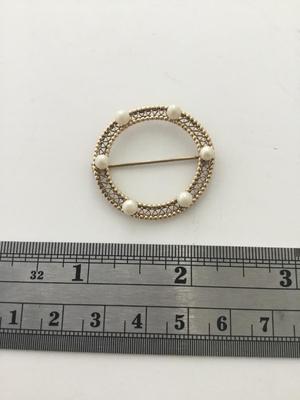Gold tone round vintage pin