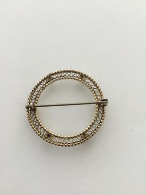 Gold tone round vintage pin