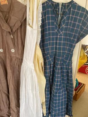 Two women’s dresses and aprons