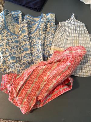 Two women’s dresses and aprons