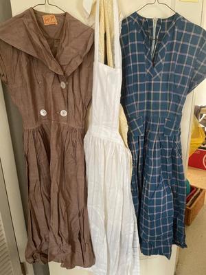 Two women’s dresses and aprons