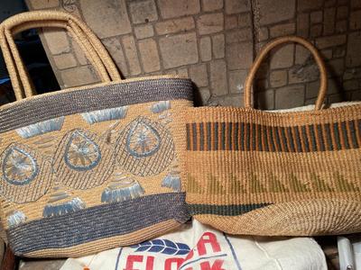 Two straw handbags, umbrellas, canes, and badminton brackets