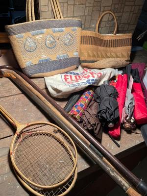 Two straw handbags, umbrellas, canes, and badminton brackets