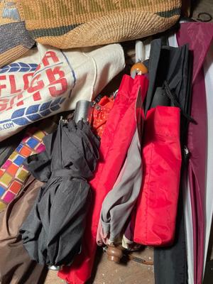 Two straw handbags, umbrellas, canes, and badminton brackets