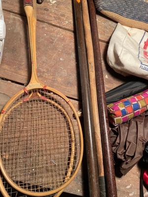 Two straw handbags, umbrellas, canes, and badminton brackets