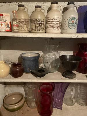 Five shelves of vases