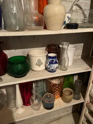 Five shelves of vases