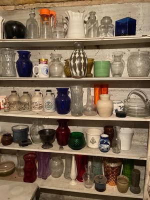 Five shelves of vases