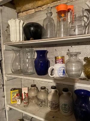 Five shelves of vases