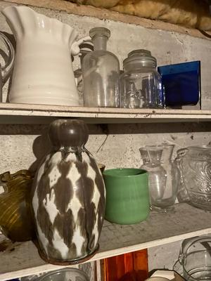 Five shelves of vases