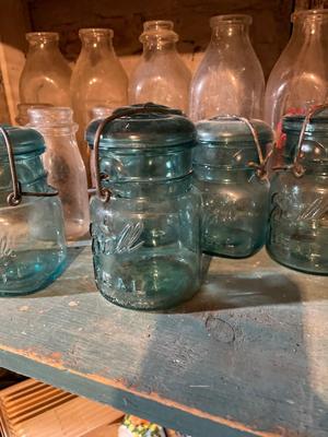 Milk bottles, and blue ball canning jars with lids
