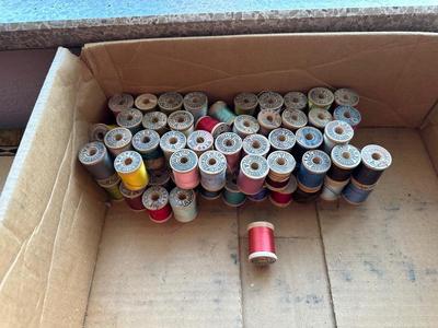 MANY WOODEN SPOOLS OF THREAD