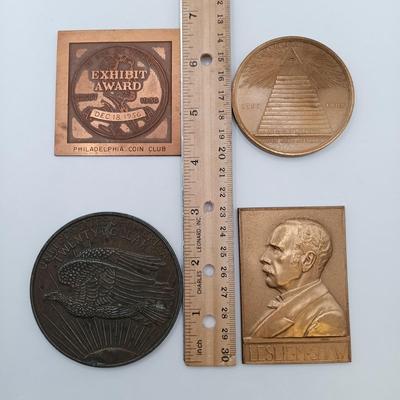 LOT 16: Set of 4 Metal Medallions with Coin Club Plaque- Philadelphia Centennial Exposition, Leslie M. Shaw & More