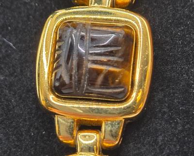 LOT 25: Gold-tone Cuff Bracelet, Gold-tone Spring Open Bracelet w/ Amber Colored Gems, and Kenneth Jay Lane Scarab Gemstone Watch