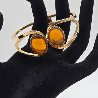 LOT 25: Gold-tone Cuff Bracelet, Gold-tone Spring Open Bracelet w/ Amber Colored Gems, and Kenneth Jay Lane Scarab Gemstone Watch