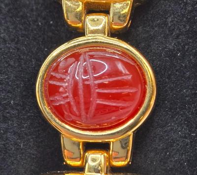 LOT 25: Gold-tone Cuff Bracelet, Gold-tone Spring Open Bracelet w/ Amber Colored Gems, and Kenneth Jay Lane Scarab Gemstone Watch