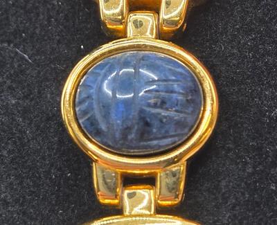 LOT 25: Gold-tone Cuff Bracelet, Gold-tone Spring Open Bracelet w/ Amber Colored Gems, and Kenneth Jay Lane Scarab Gemstone Watch